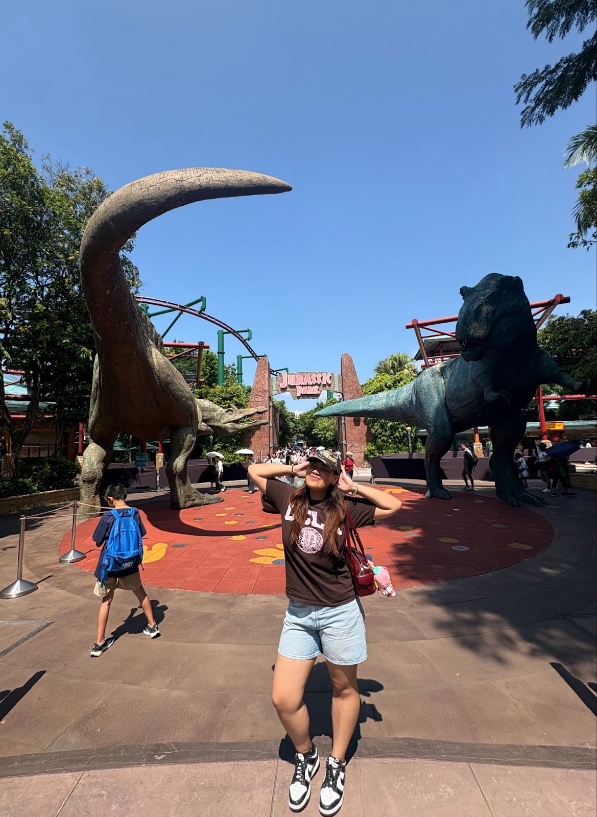 Proudly wearing her alma mater in Universal Studios Singapore